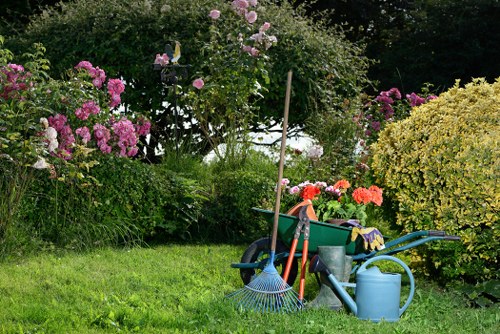 Gardener inspecting a Mill Hill garden with clipboard